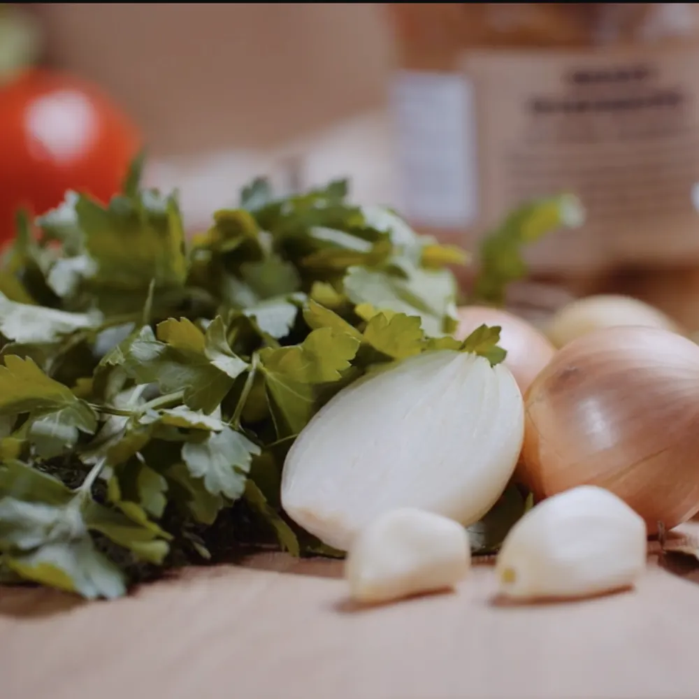 Fresh onions and greens laid out for an Iron Chef Core session