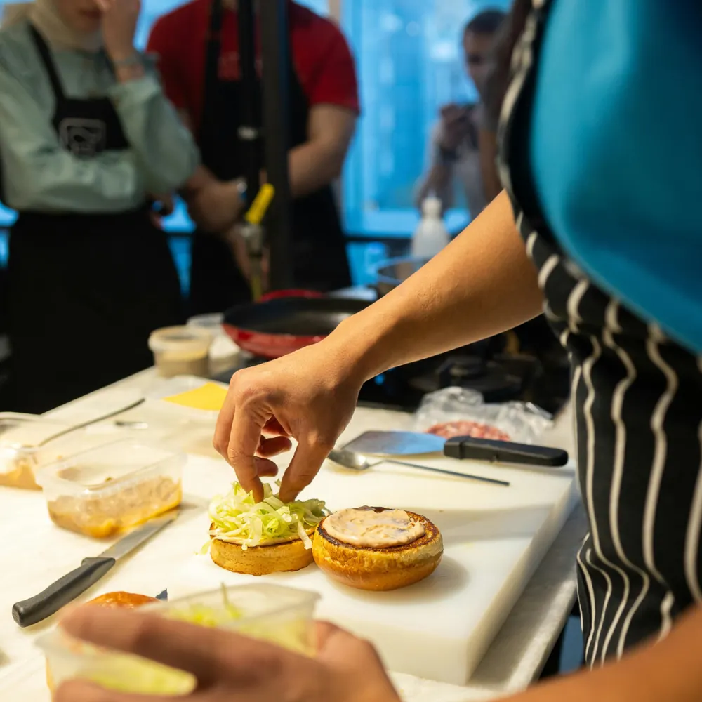 A team-building participant plating a course