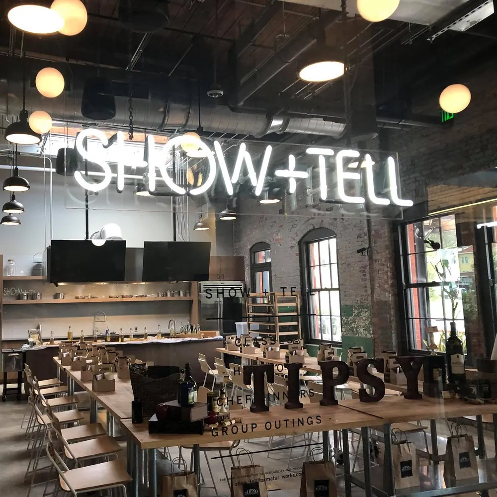 The Show + Tell neon sign inside Armature Works